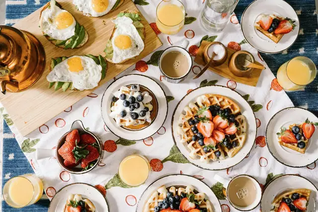 A brunch tasting spread with pastries, eggs and fruit