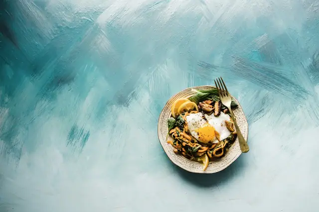A plated dish of soft egg and greens